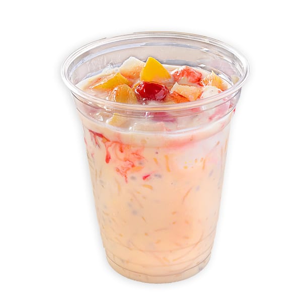A clear plastic cup of Pakistani falooda, a creamy dessert with noodles, fruit, and syrup.